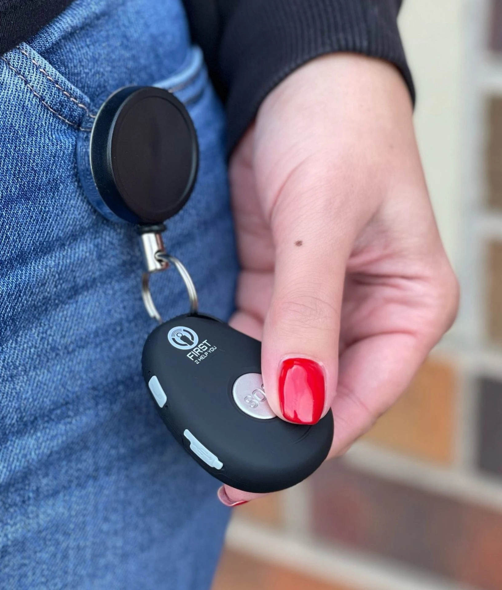 Retractable Keychain clipped to belt and to hold and retract a Lone Worker Device